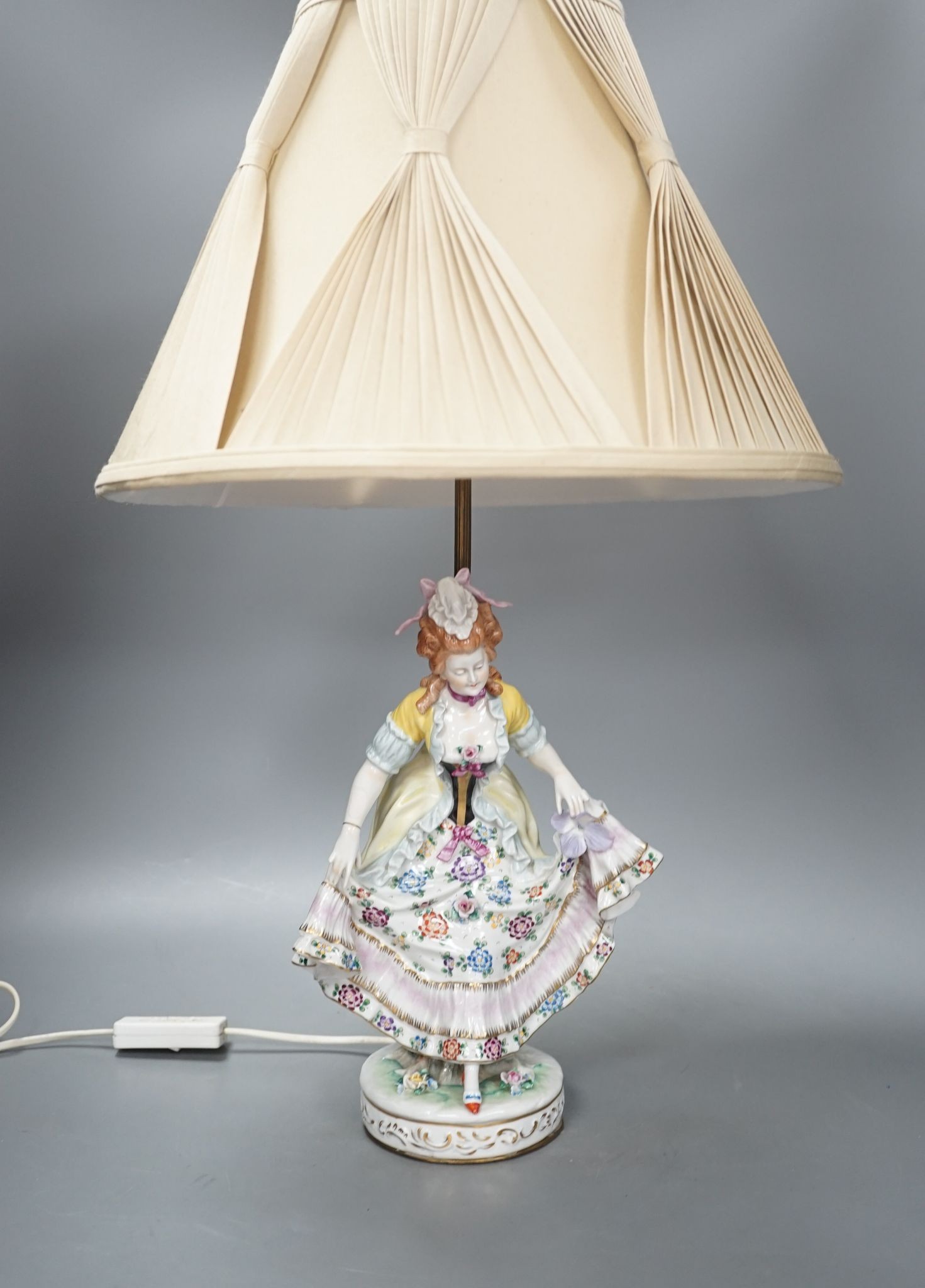 A German porcelain ‘dancing lady’ lamp, figure 29 cms high.